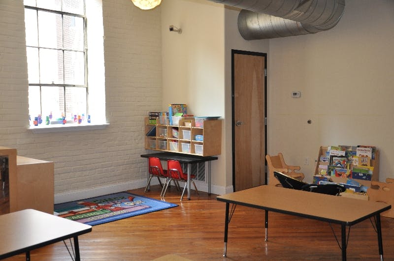 Empty classroom with small tables and chairs