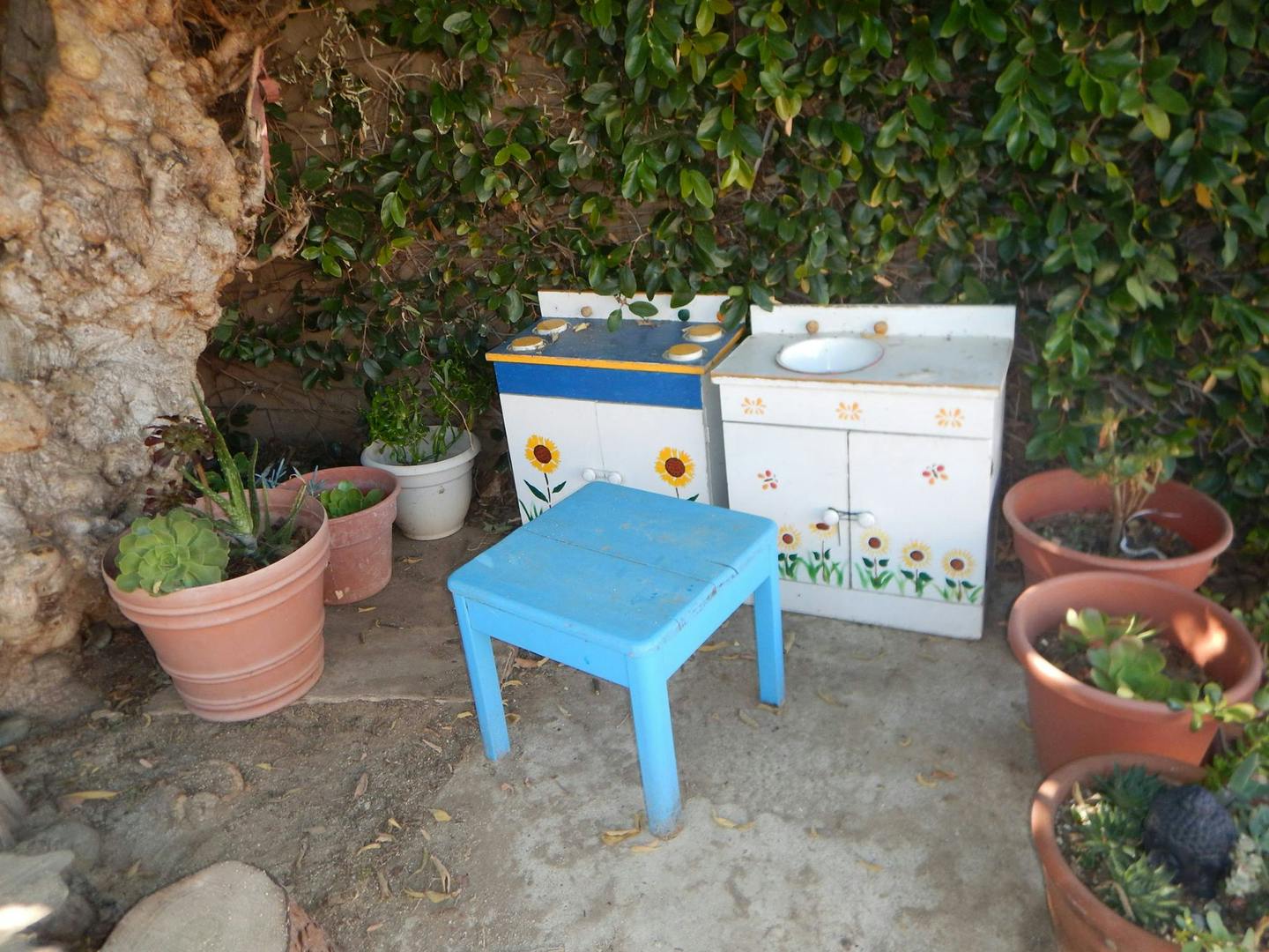 Blue table and two play kitchen units with sunflower decorations