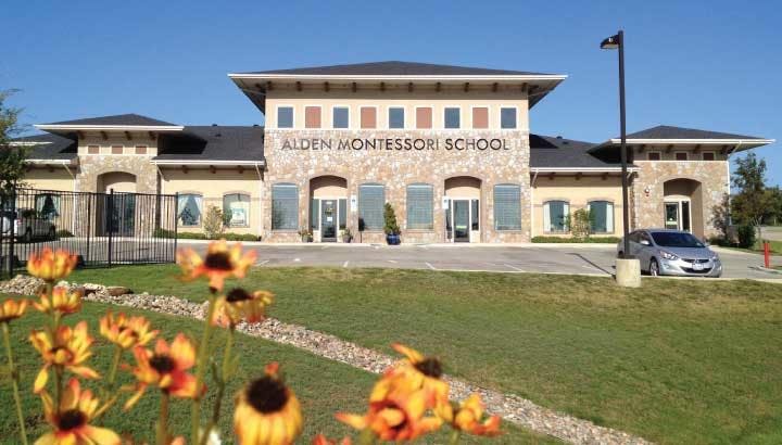 Auden Montessori School building exterior with flowers in foreground