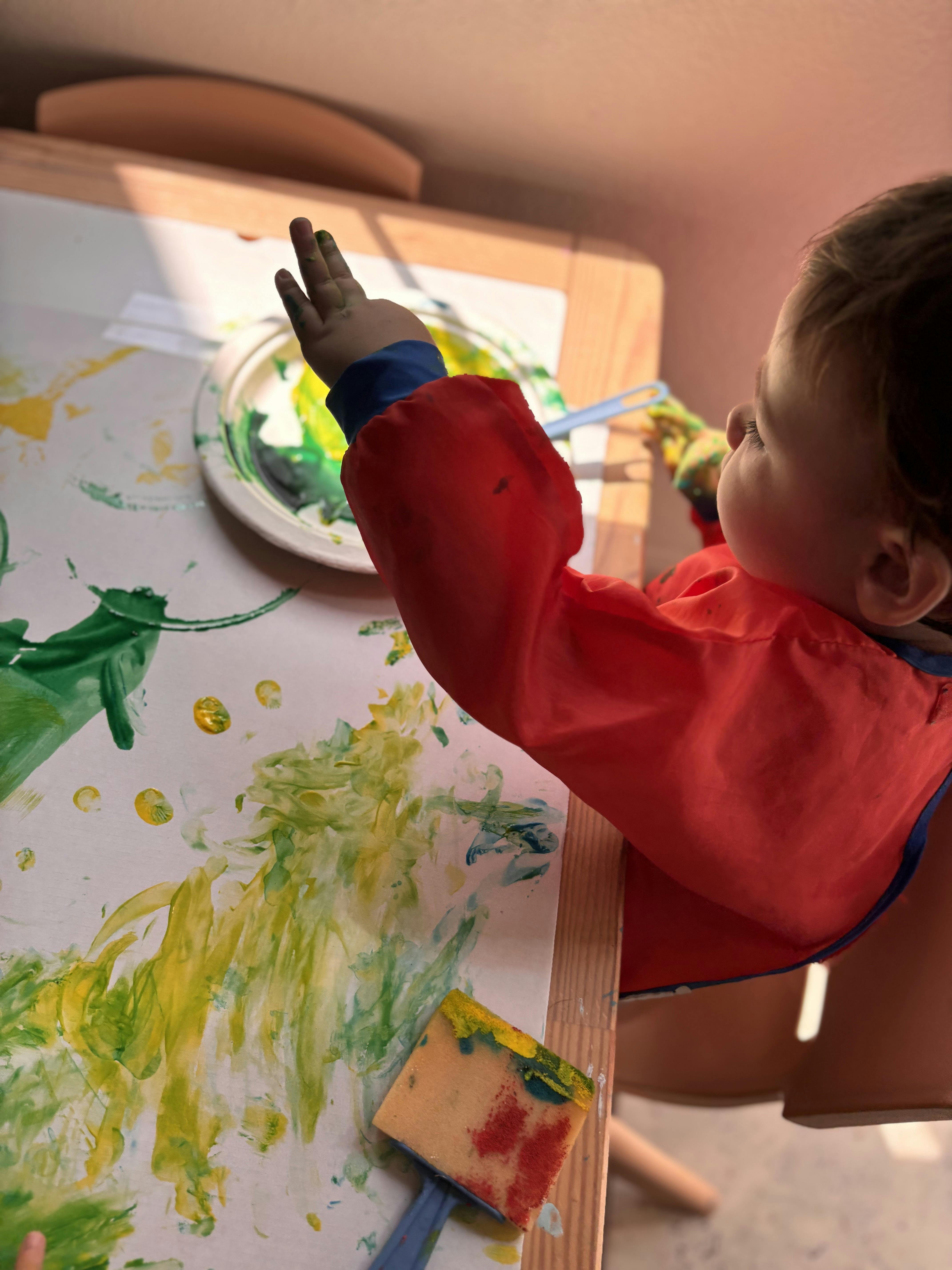 Child painting on paper at a table