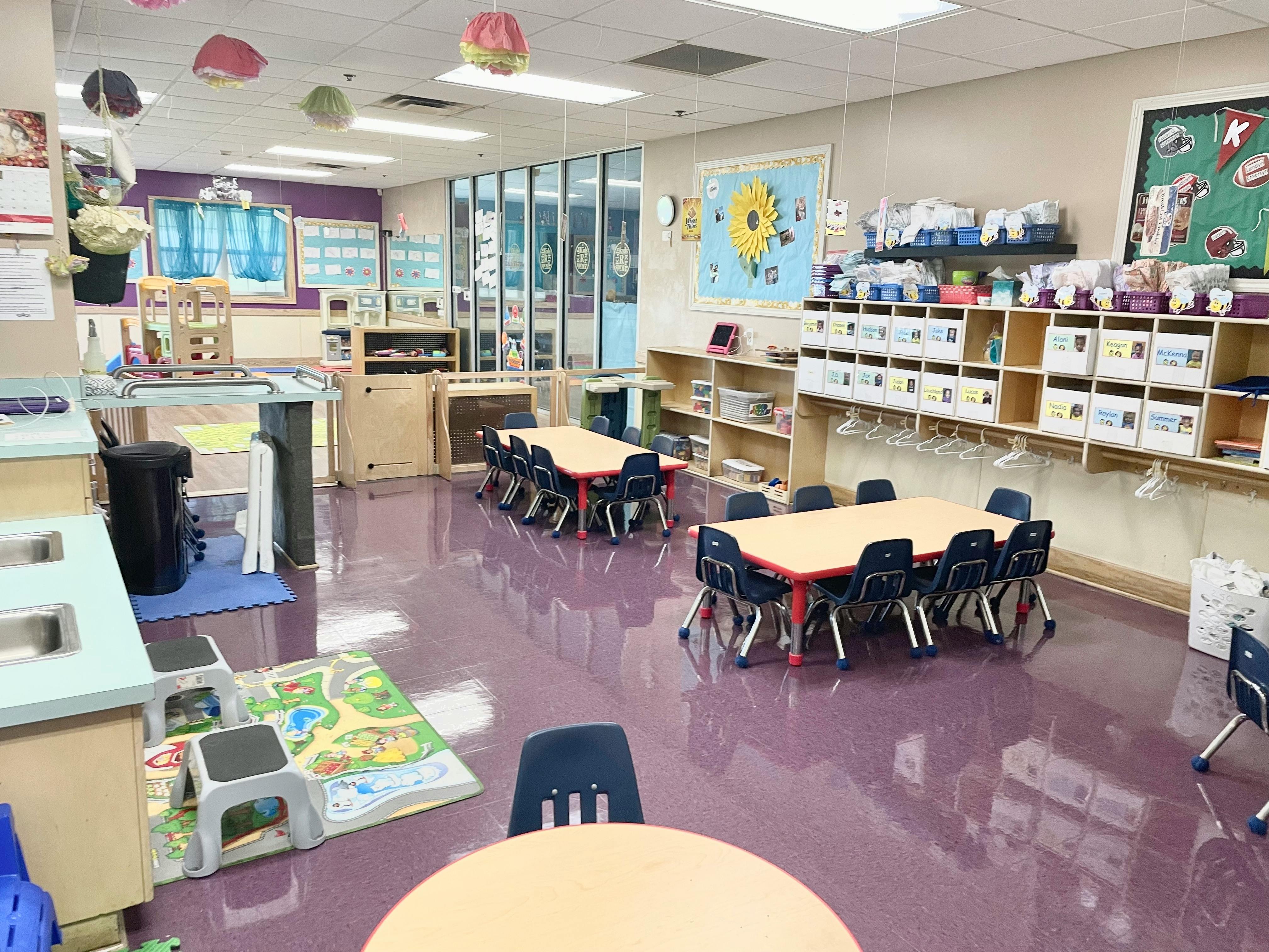 Empty classroom with small tables and chairs