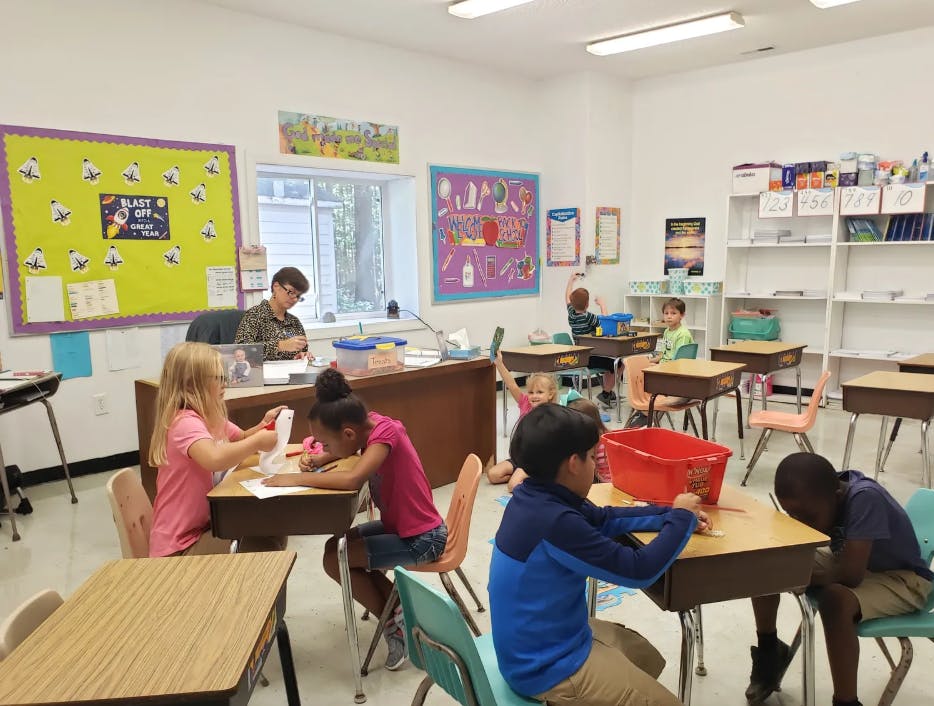Children working at desks in a classroom