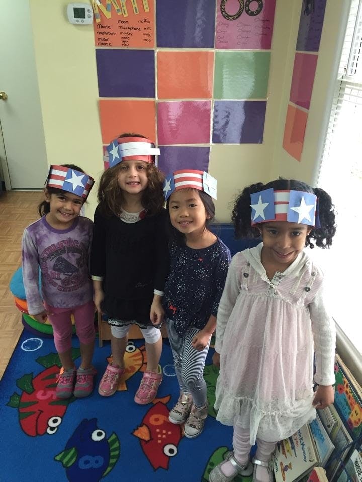 Four children wearing patriotic headbands