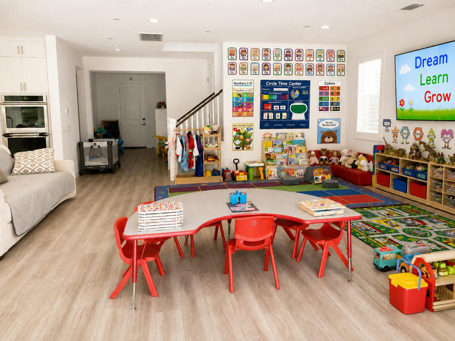 Childcare room with learning posters, toys, and a central play table