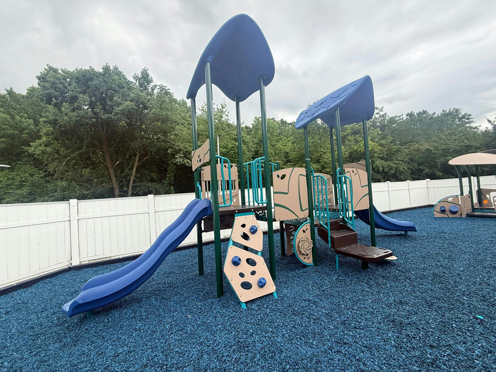 Playground structure with slides and climbing walls