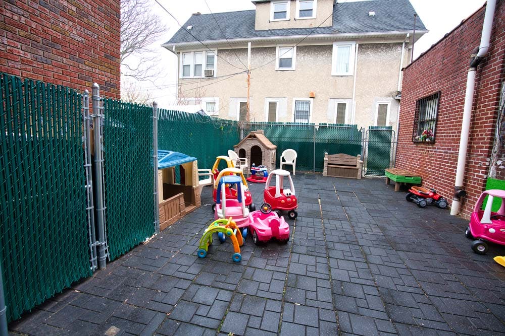 Outdoor play area with toy cars and playhouses