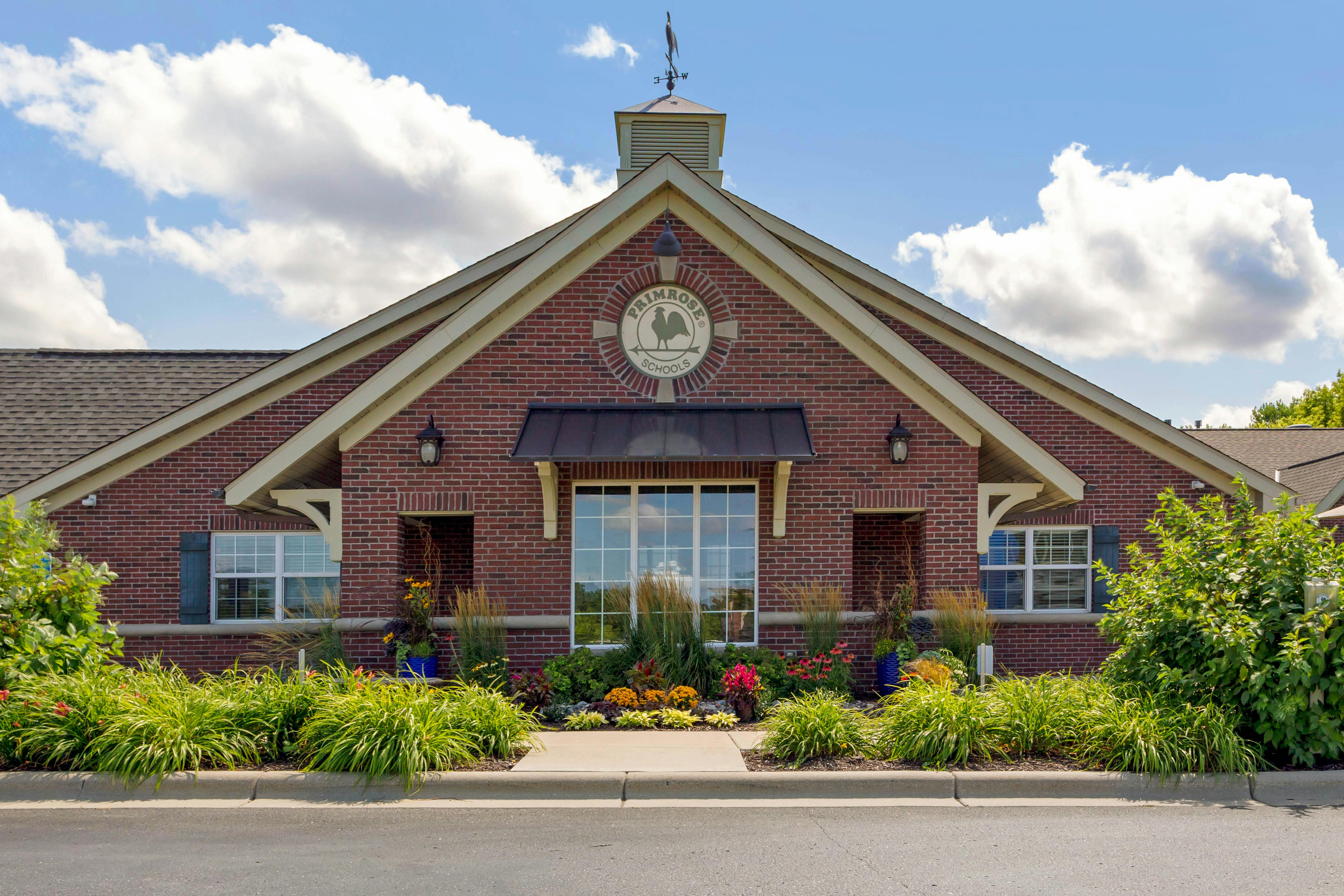 Brick building with Primrose Schools logo above the entrance, landscaping in front