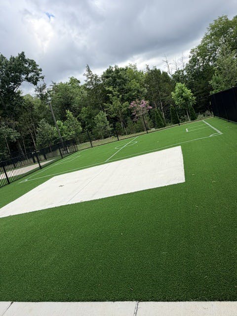 Small soccer field with artificial turf and a concrete center section