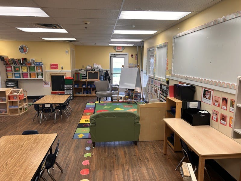 Classroom with small tables, chairs, and learning materials