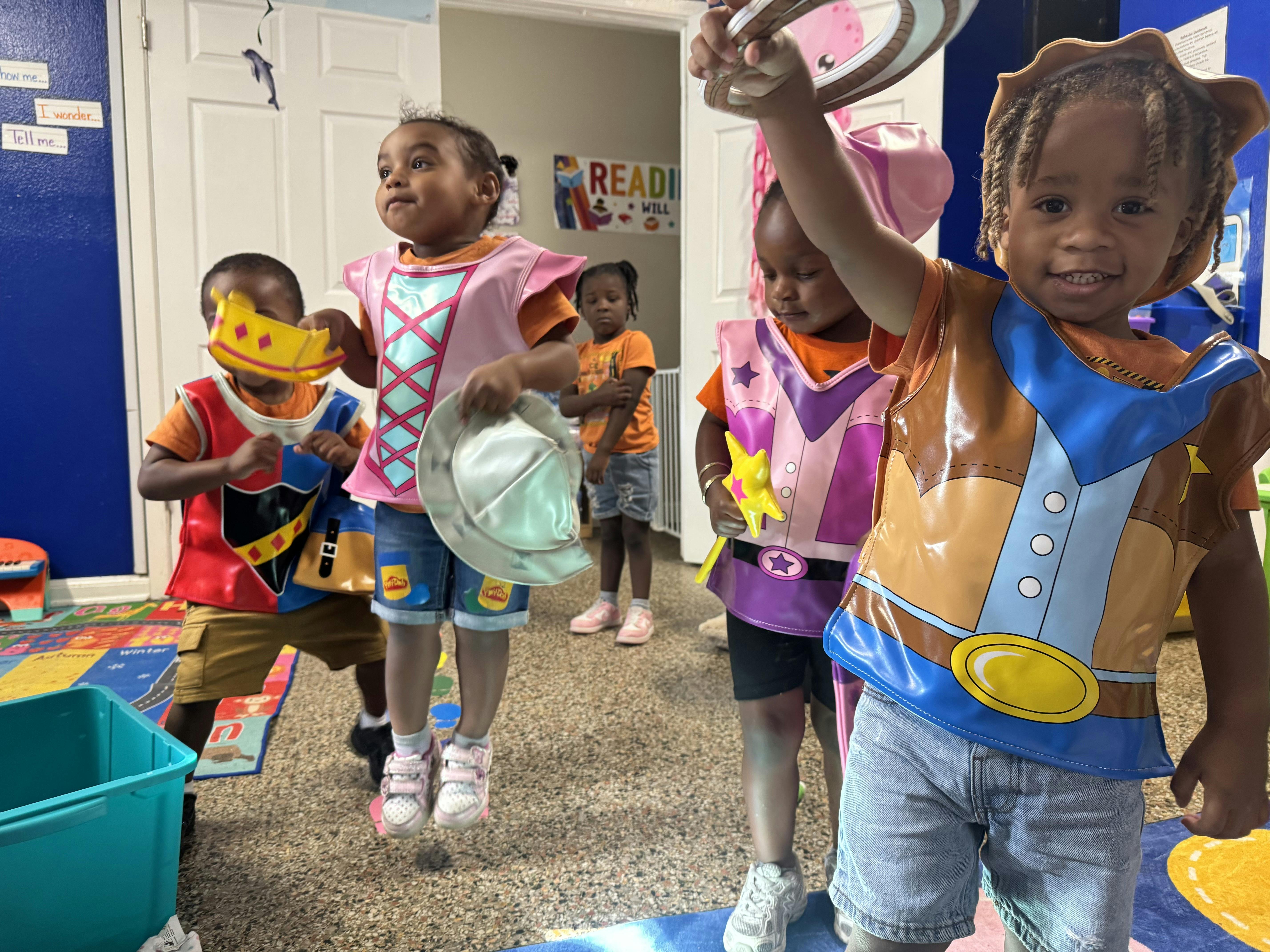 Children in costumes playing indoors