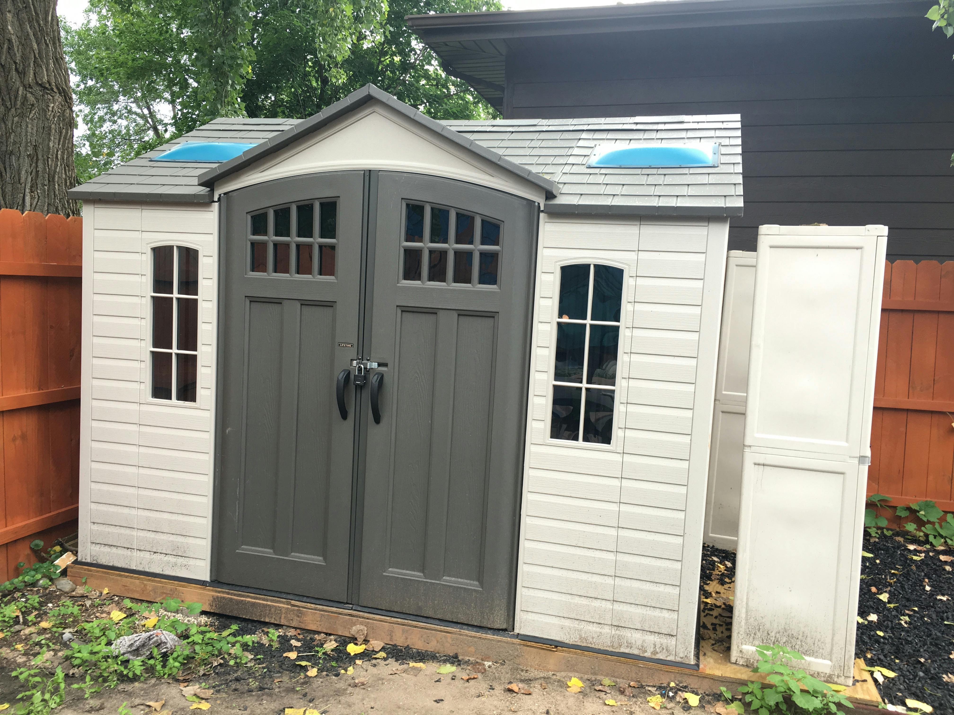 Outdoor storage shed with double doors and windows