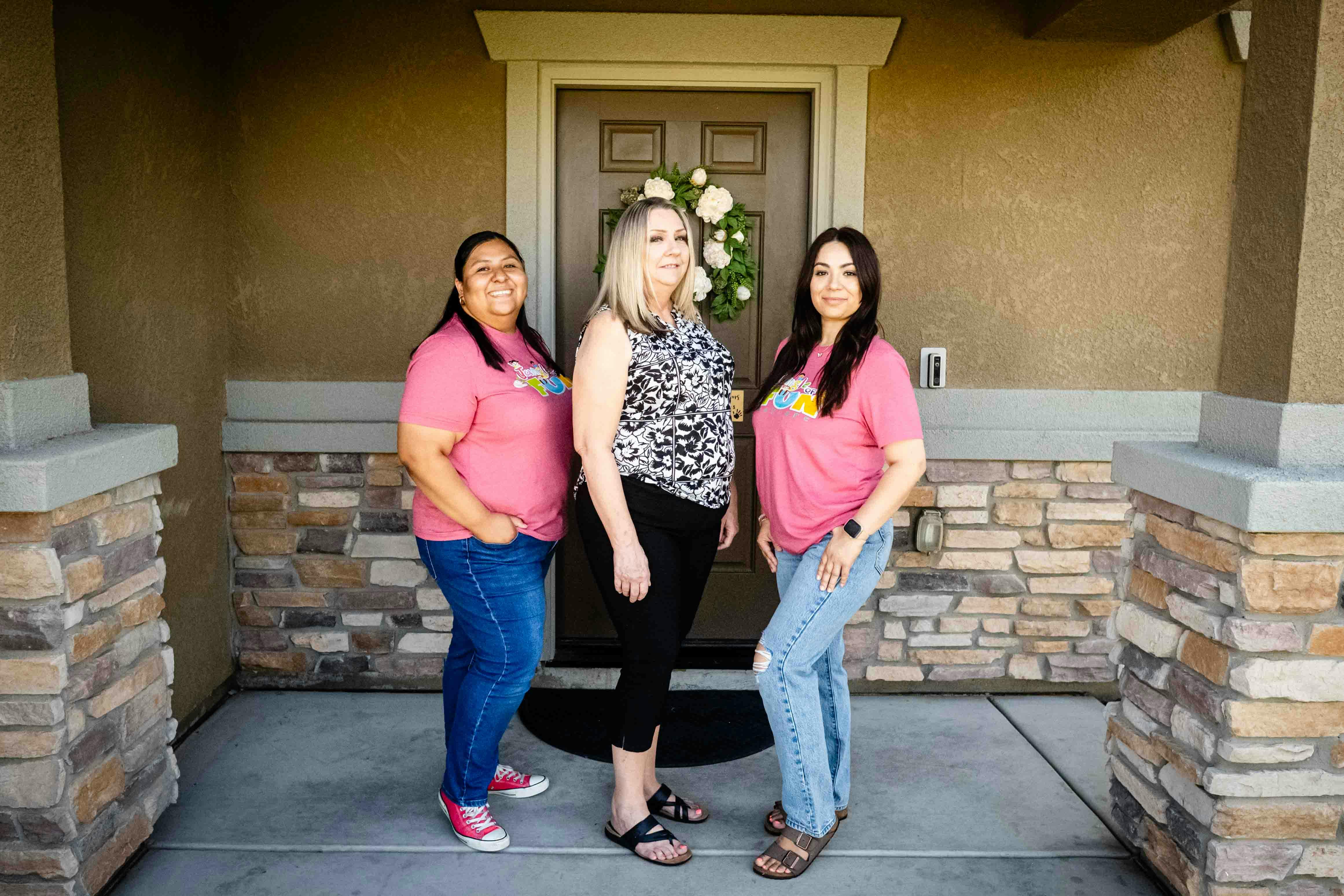 Three people standing in front of a door
