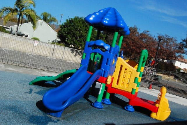 Colorful playground structure with slides and climbing elements