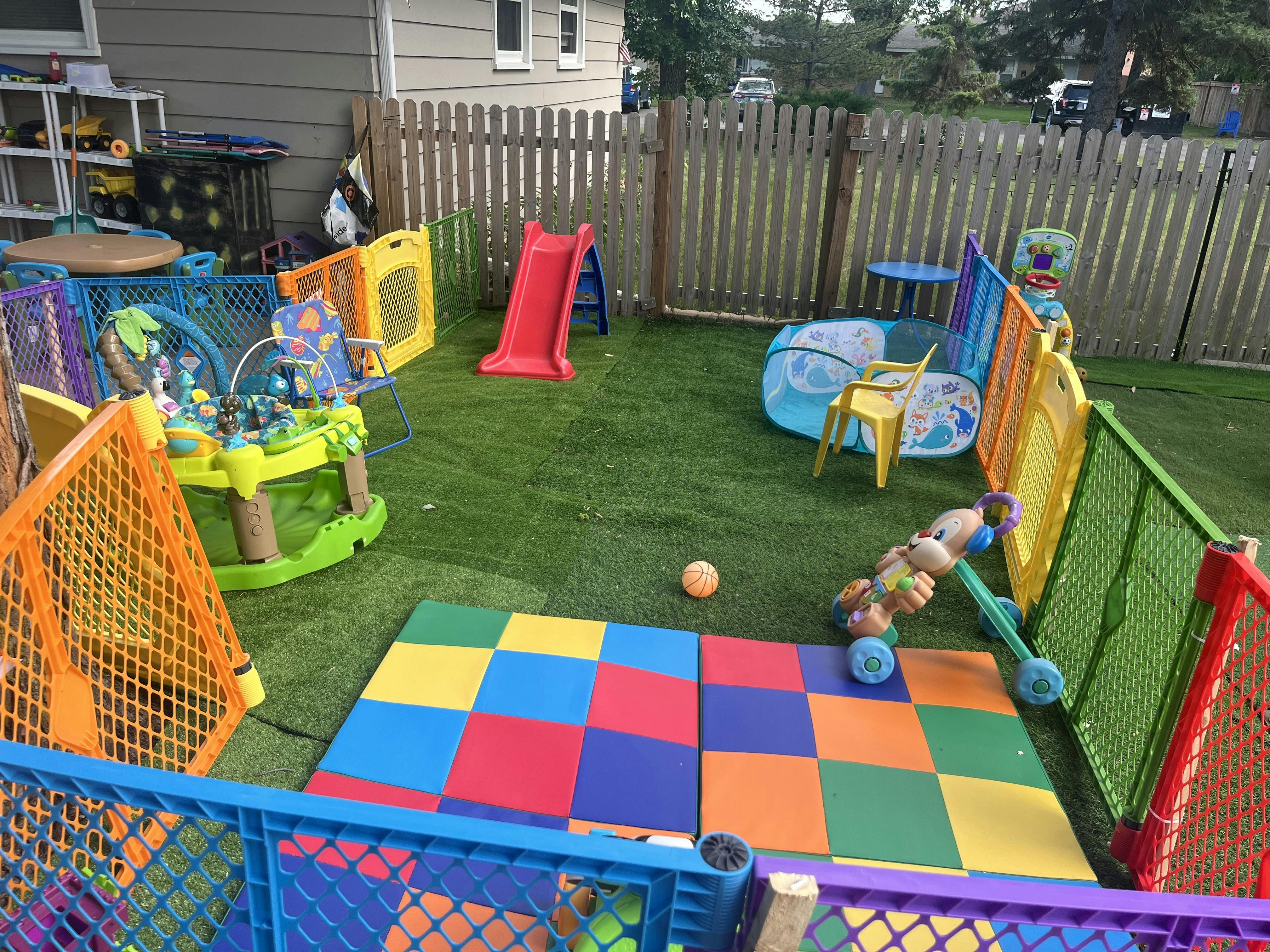 Colorful playground area for children with plastic fences and toy equipment