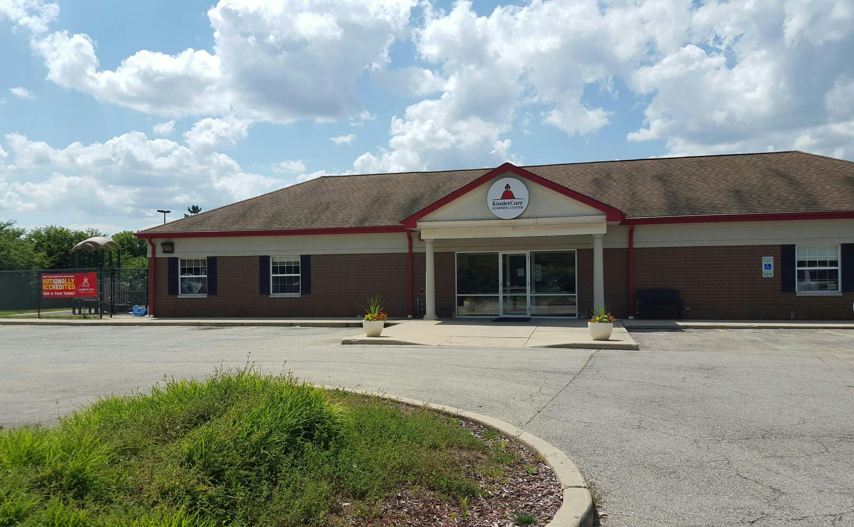 KinderCare Learning Center building with a playground and sign