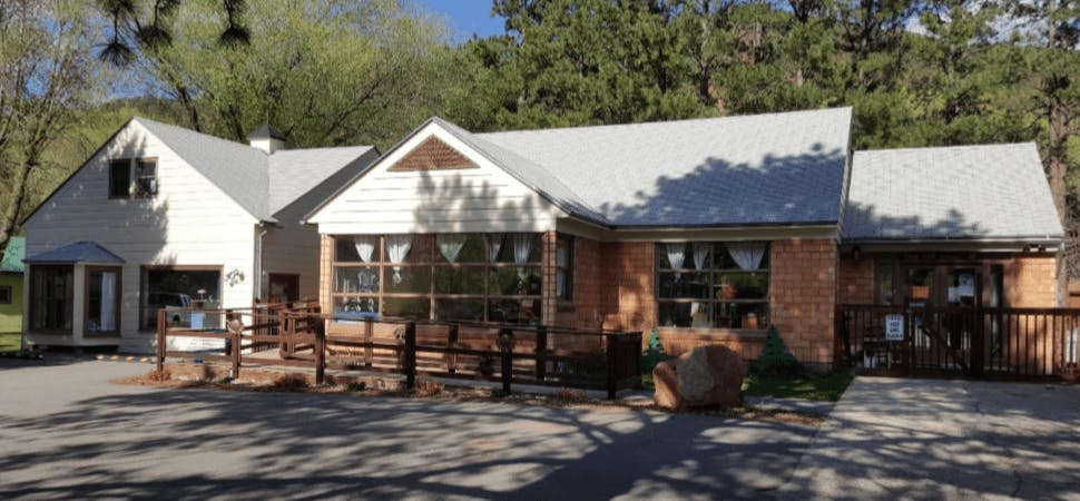Building with multiple windows and a wooden fence in front