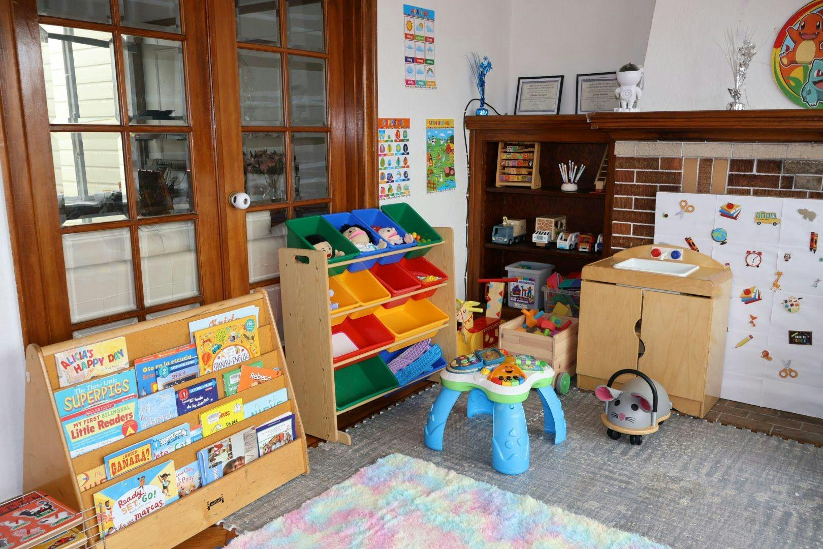 Children's play area with toy storage, bookshelf, and small table