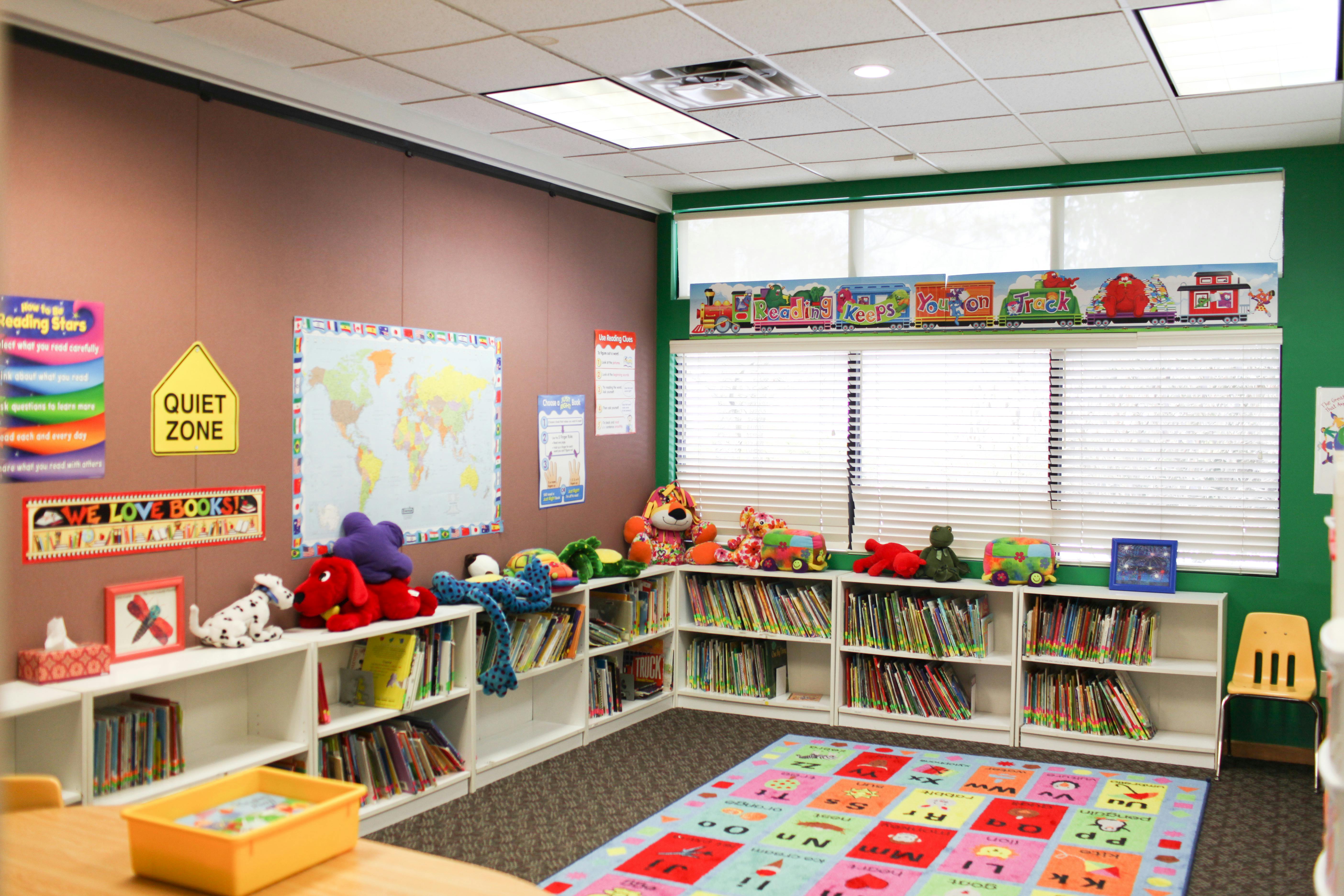 Classroom with bookshelves, toys, and a colorful rug
