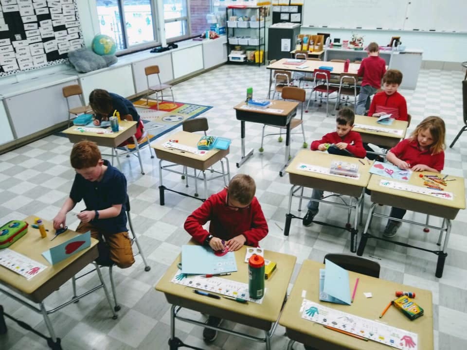 Children working at desks in a classroom