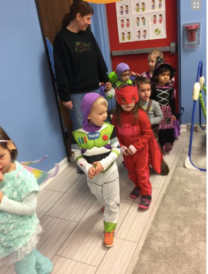 Adult and children in costumes standing in a line