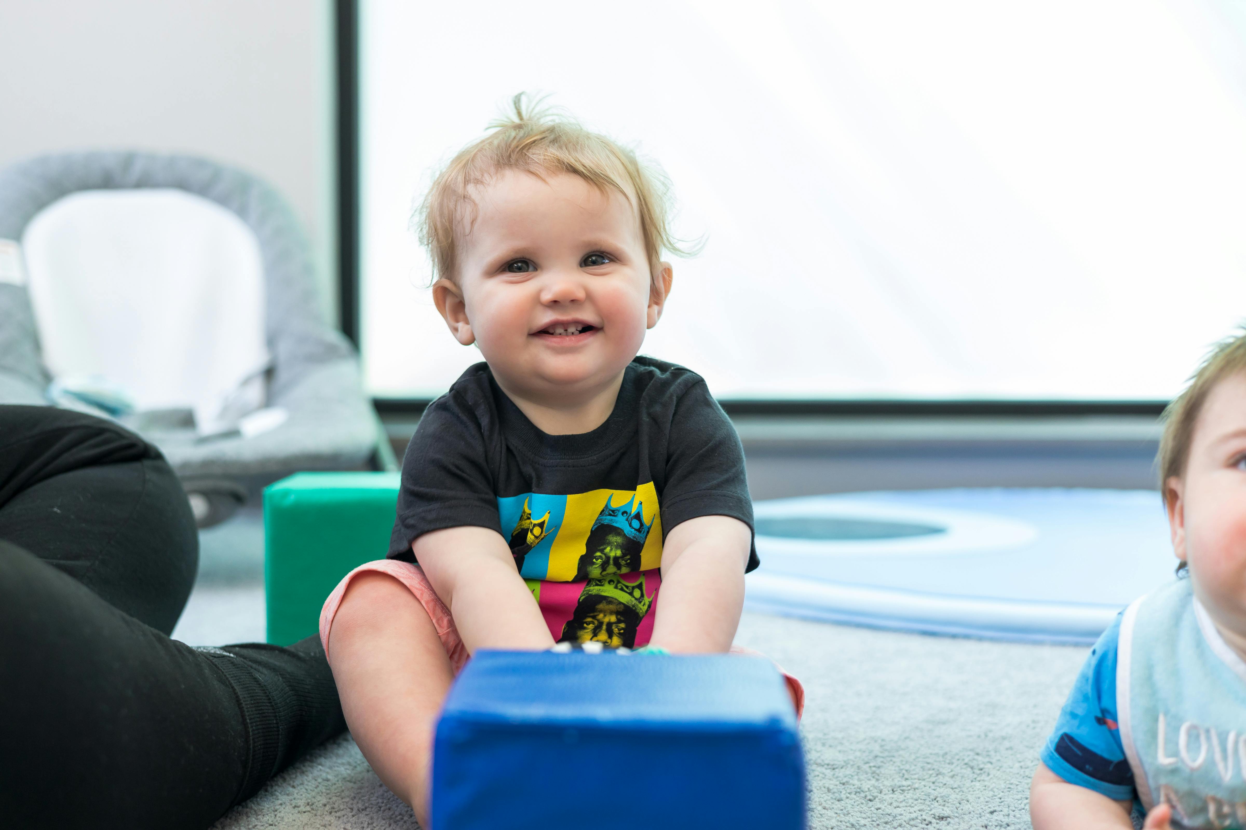 Child sitting on floor with blocks