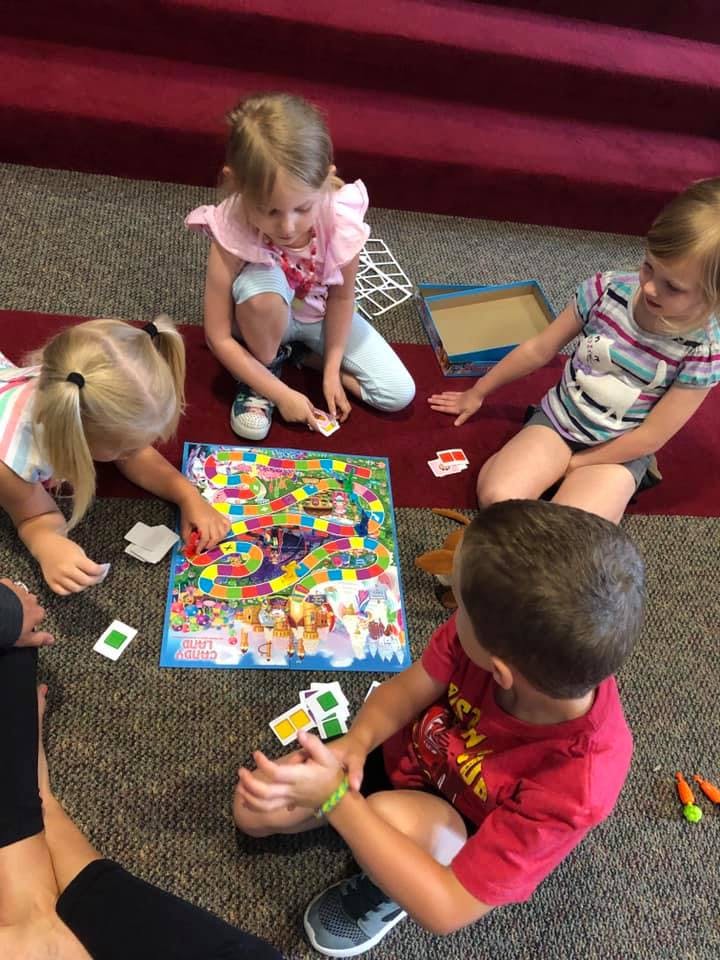Children playing a board game on the floor