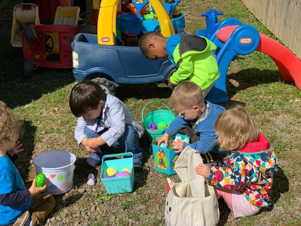 Children playing with toys and baskets outdoors