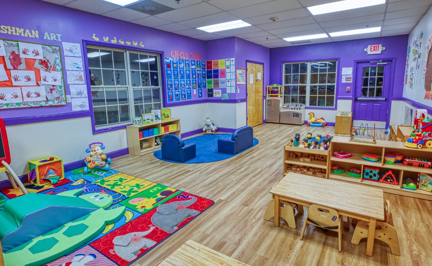 An empty early childhood classroom with colorful walls and toys