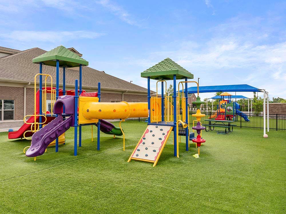 Colorful playground equipment on green artificial turf