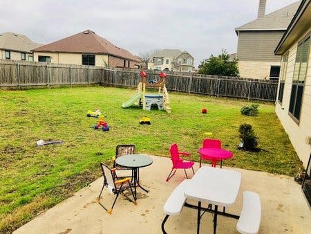 Backyard with patio furniture and children's play equipment