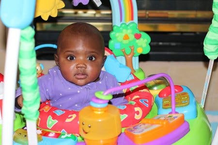 Child in a colorful baby activity center