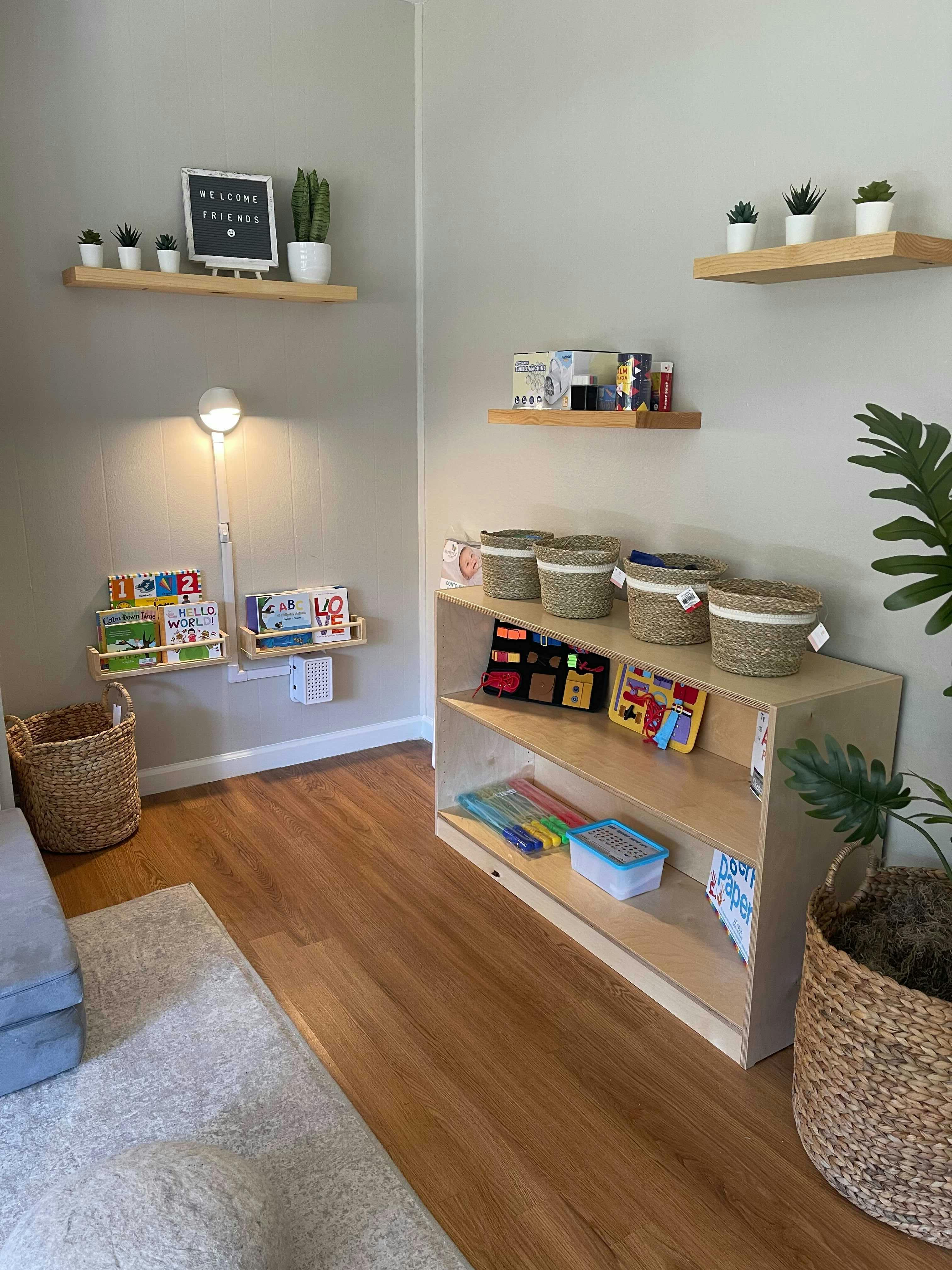 Room with shelves, books, baskets, and plants