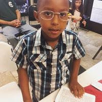 Child wearing glasses and a plaid shirt