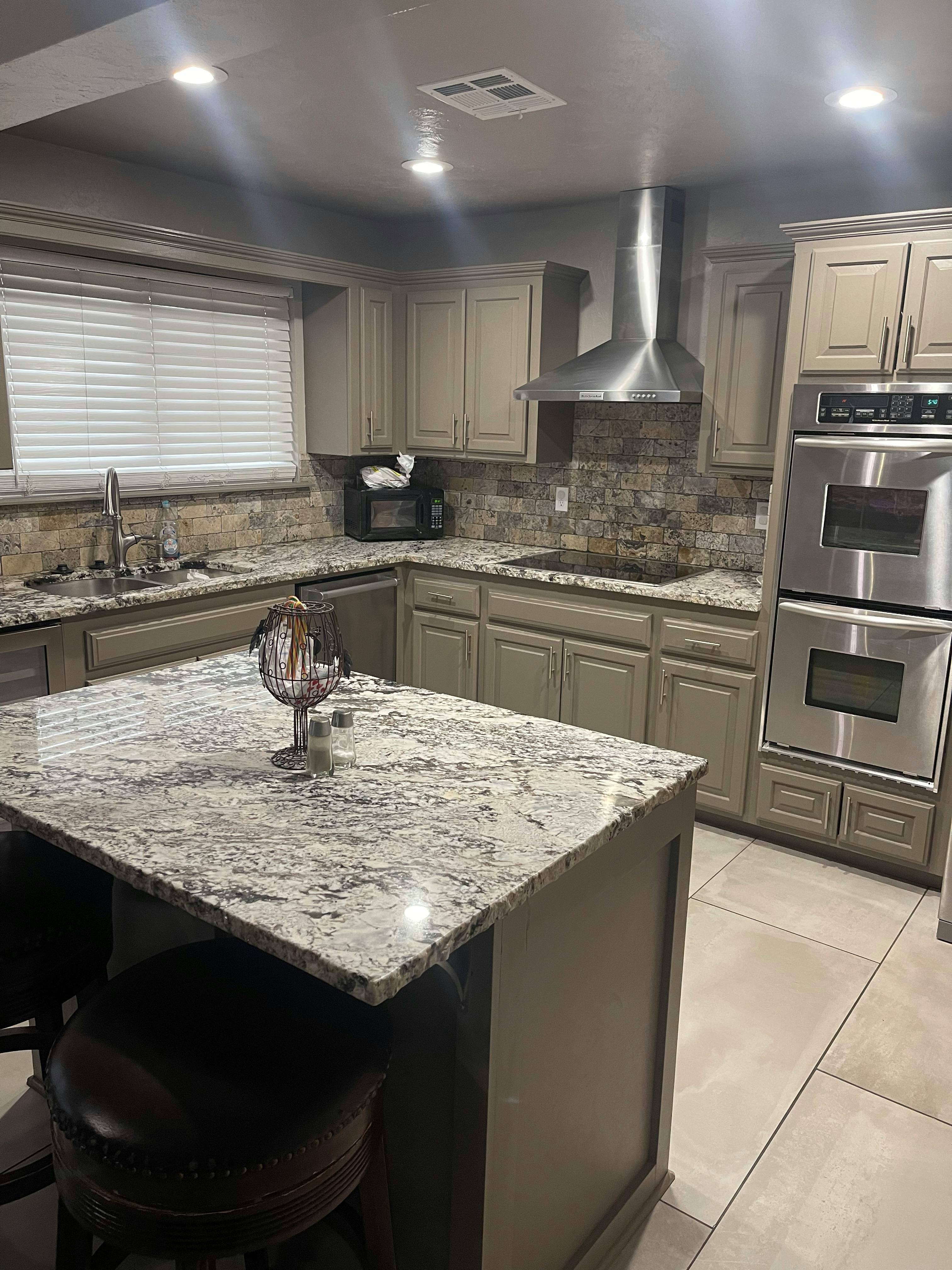 Kitchen with granite countertops, stainless steel appliances, and island