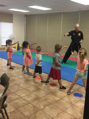 Adult teaching martial arts to children