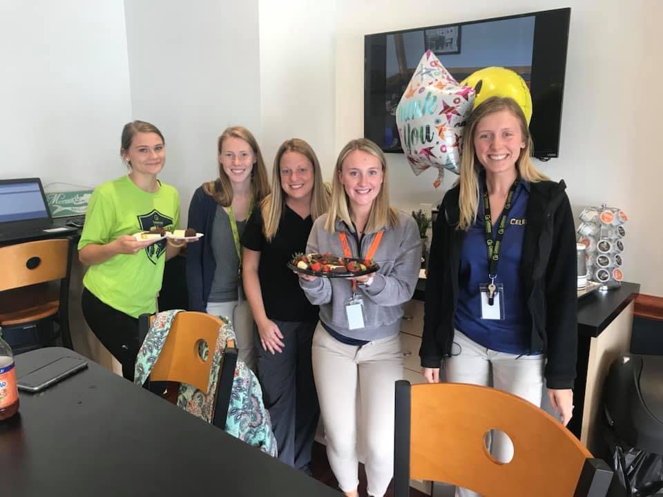 Five people holding plates of food
