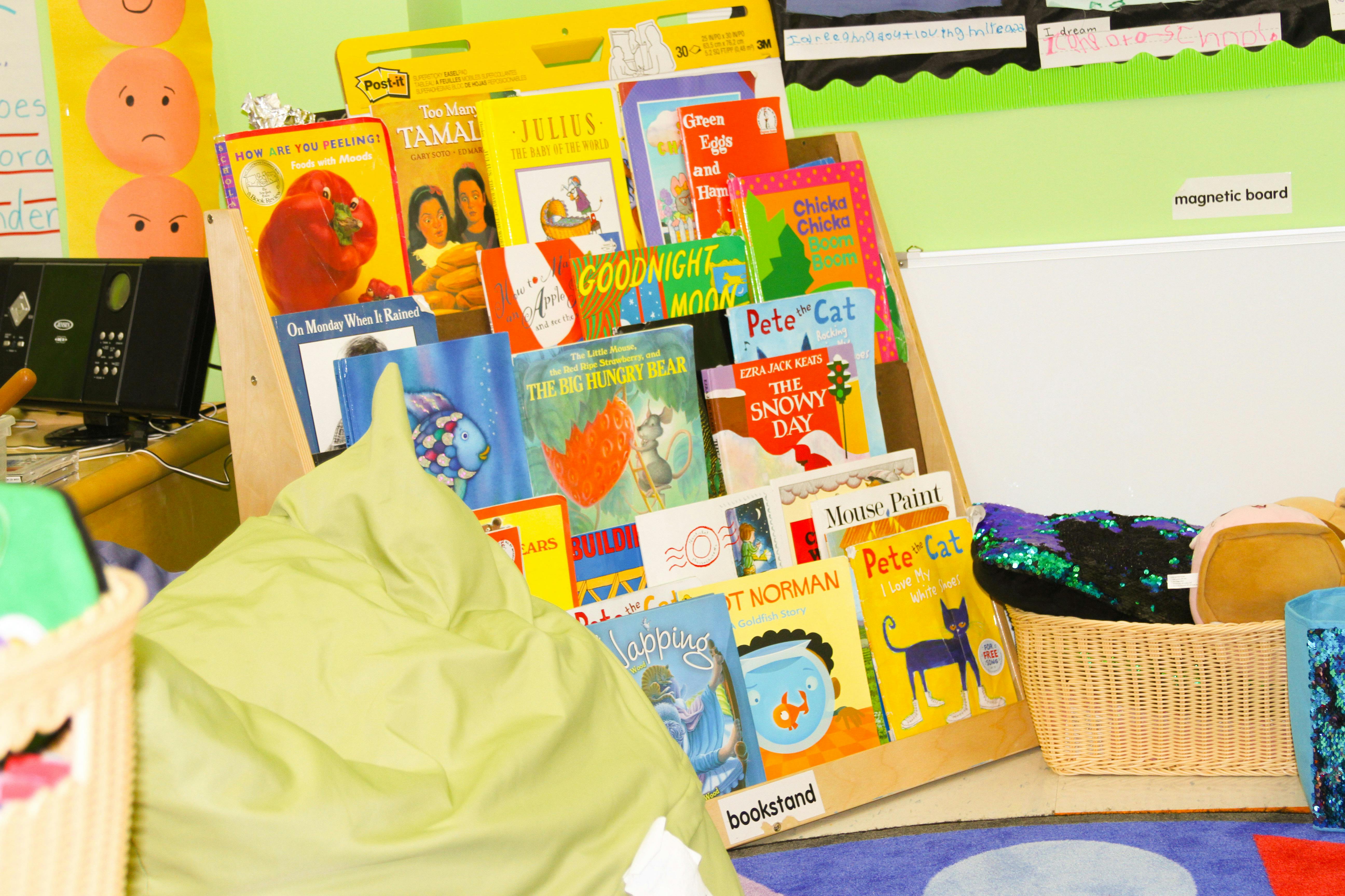 Children's books displayed on a wooden shelf