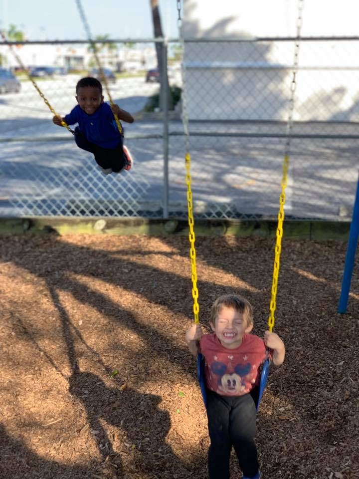Two children on swings at a playground