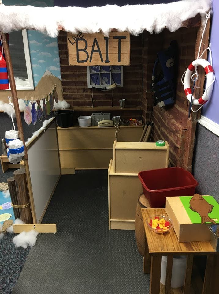 Play area designed as a bait shop with a "BAIT" sign and a life preserver
