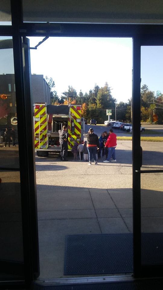 People gathered around the back of a fire truck
