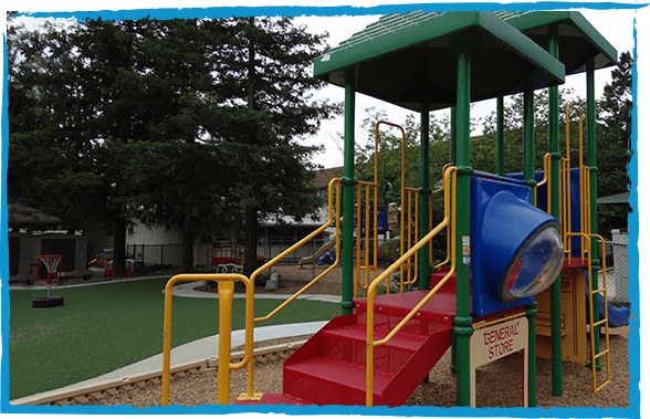 Playground structure with red stairs, yellow railings, and a blue slide