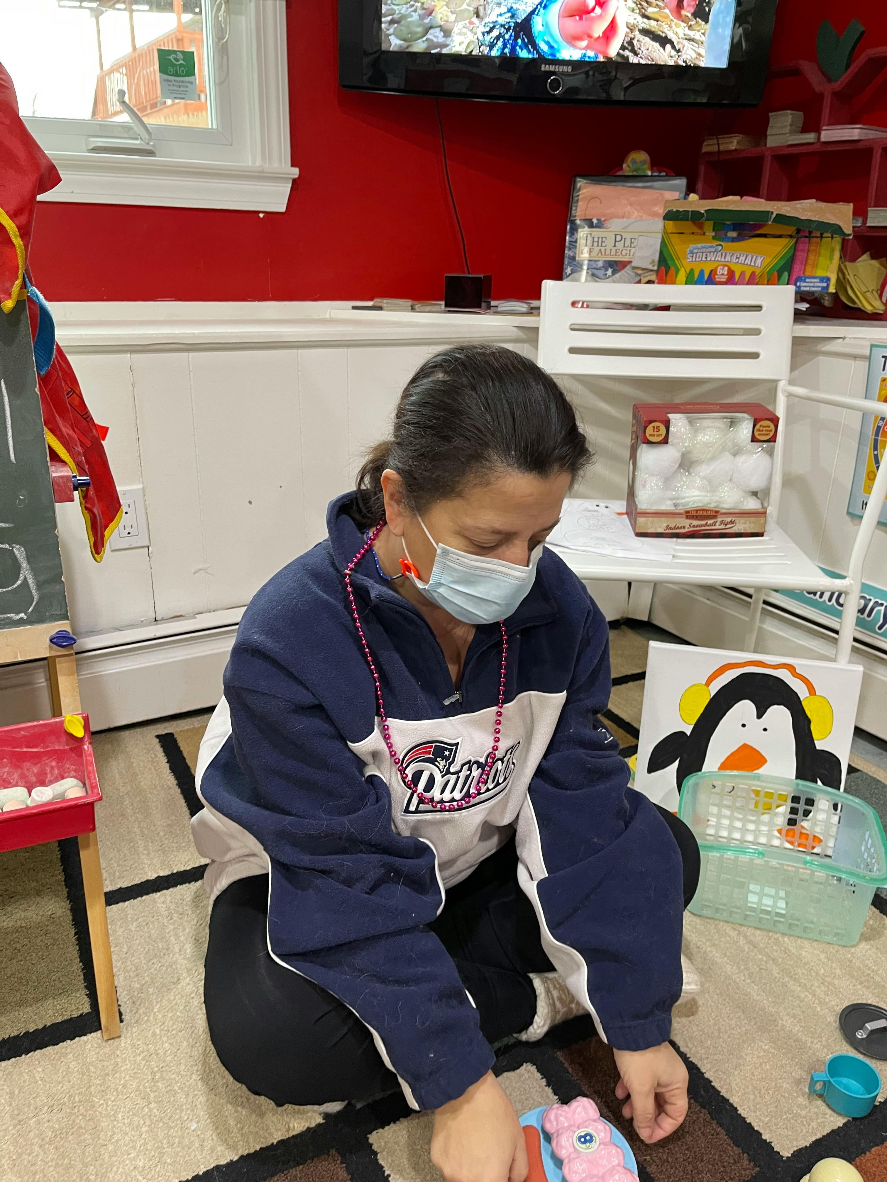 Person in a face mask kneeling on the floor