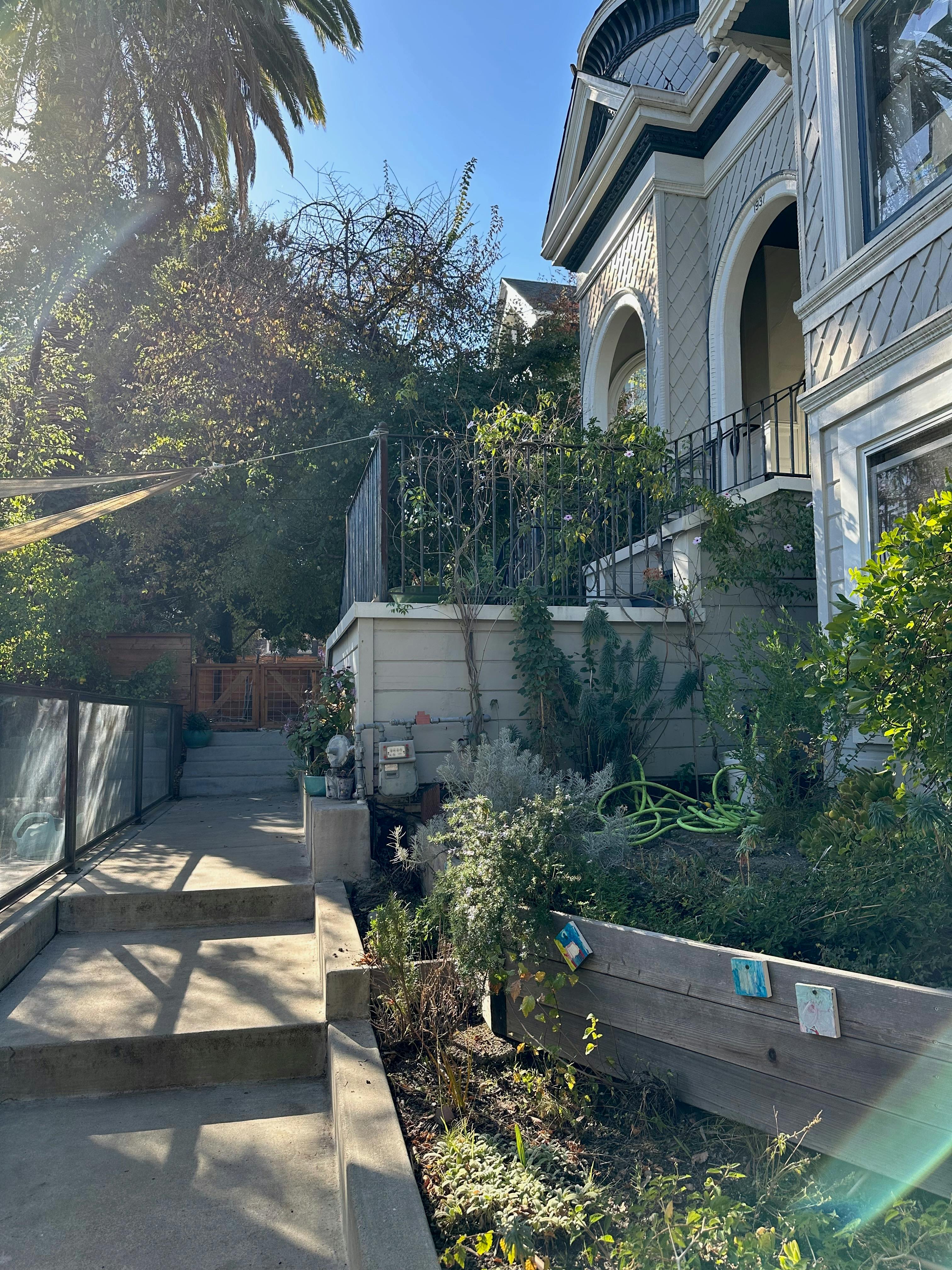 Concrete steps leading up to a house with a garden and garden