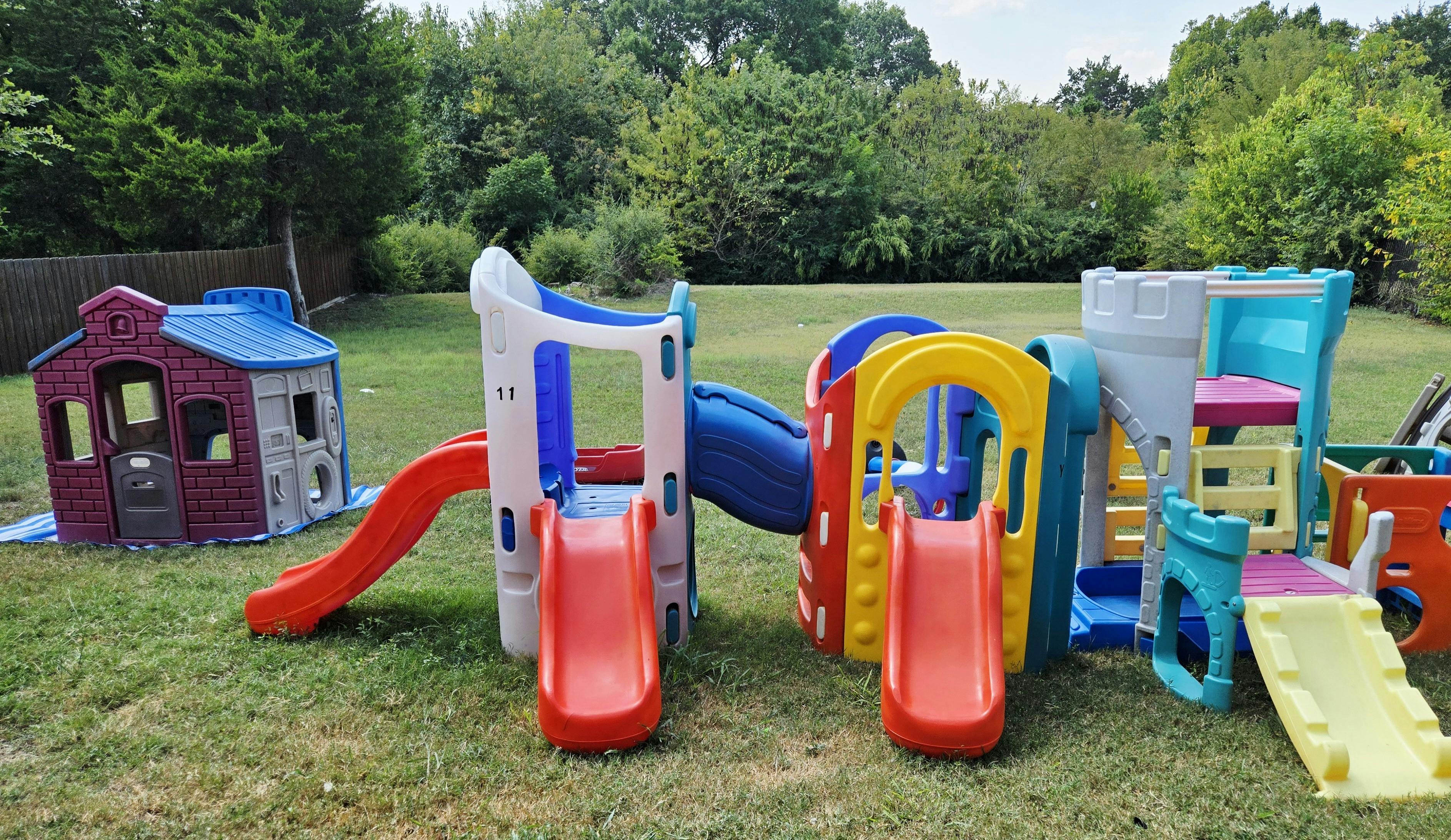 Outdoor playground with multiple slides and a playhouse