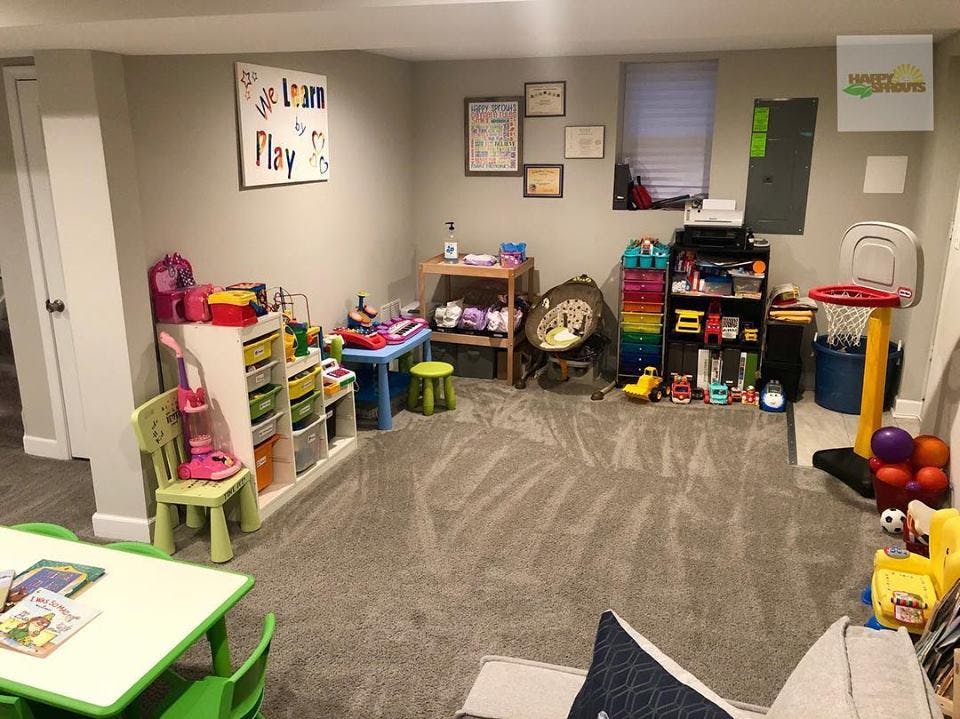Playroom with toys, shelves, and a small table