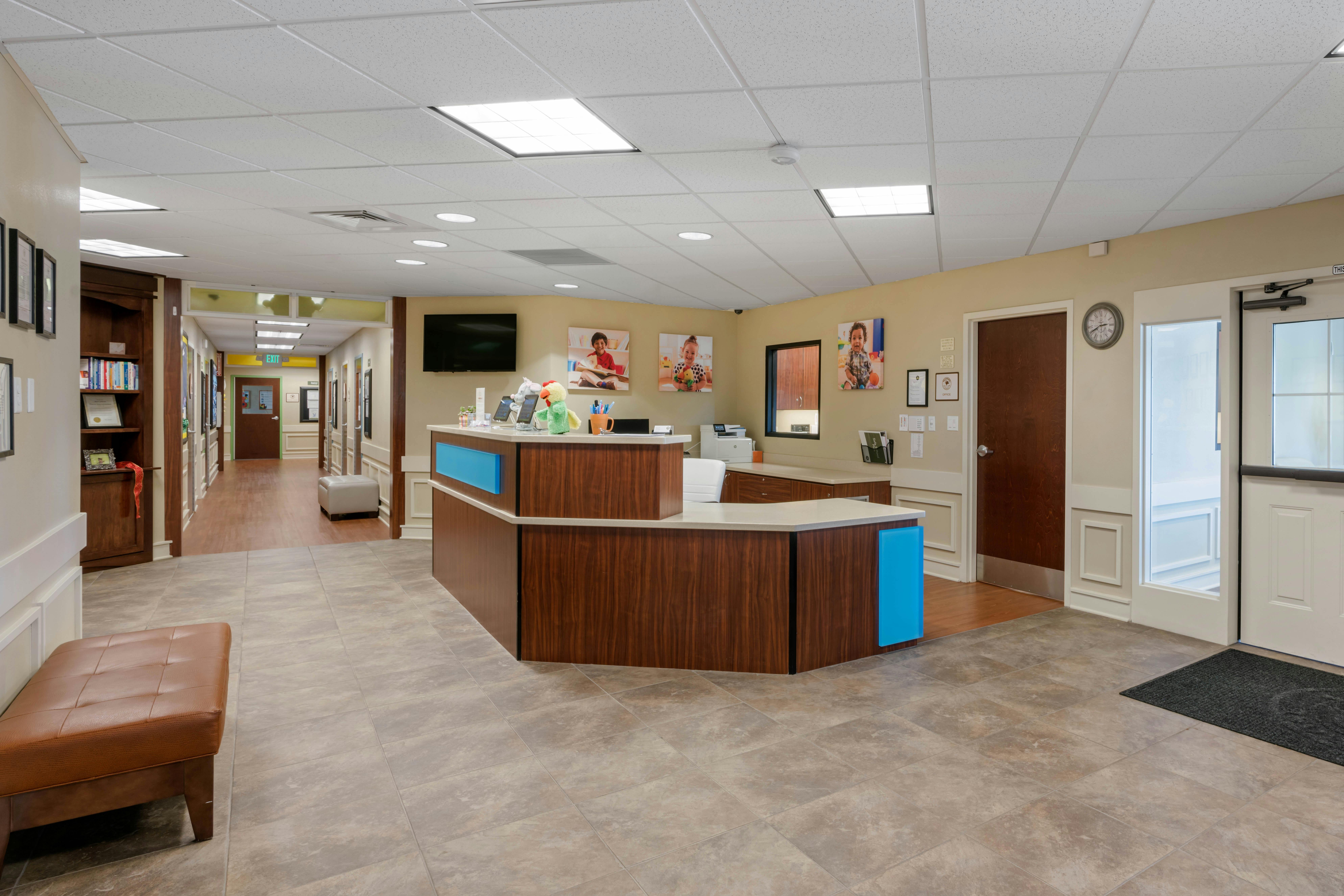 Reception desk in an office building with a hallway and doors