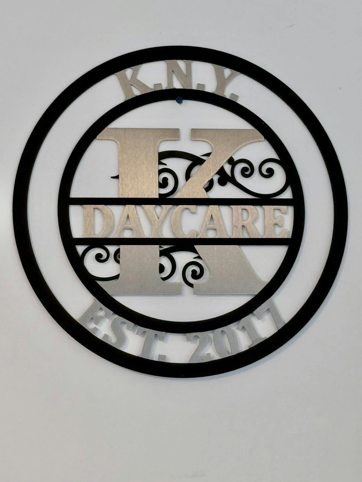 Decorative circular wall sign reading K.N.Y. Daycare Est. 2017