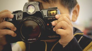 Child holding a camera to their face