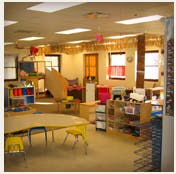 Empty classroom with small tables and chairs