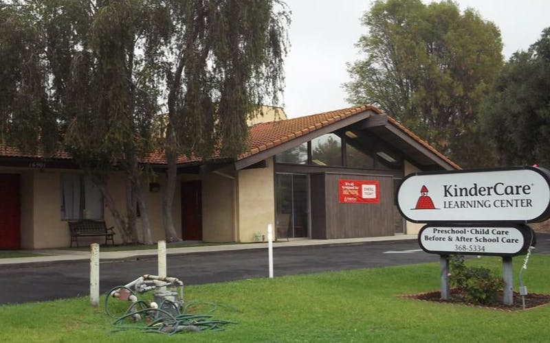 KinderCare Learning Center sign in front of a building with trees